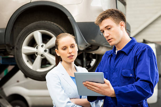 motor mechanics servicing a car