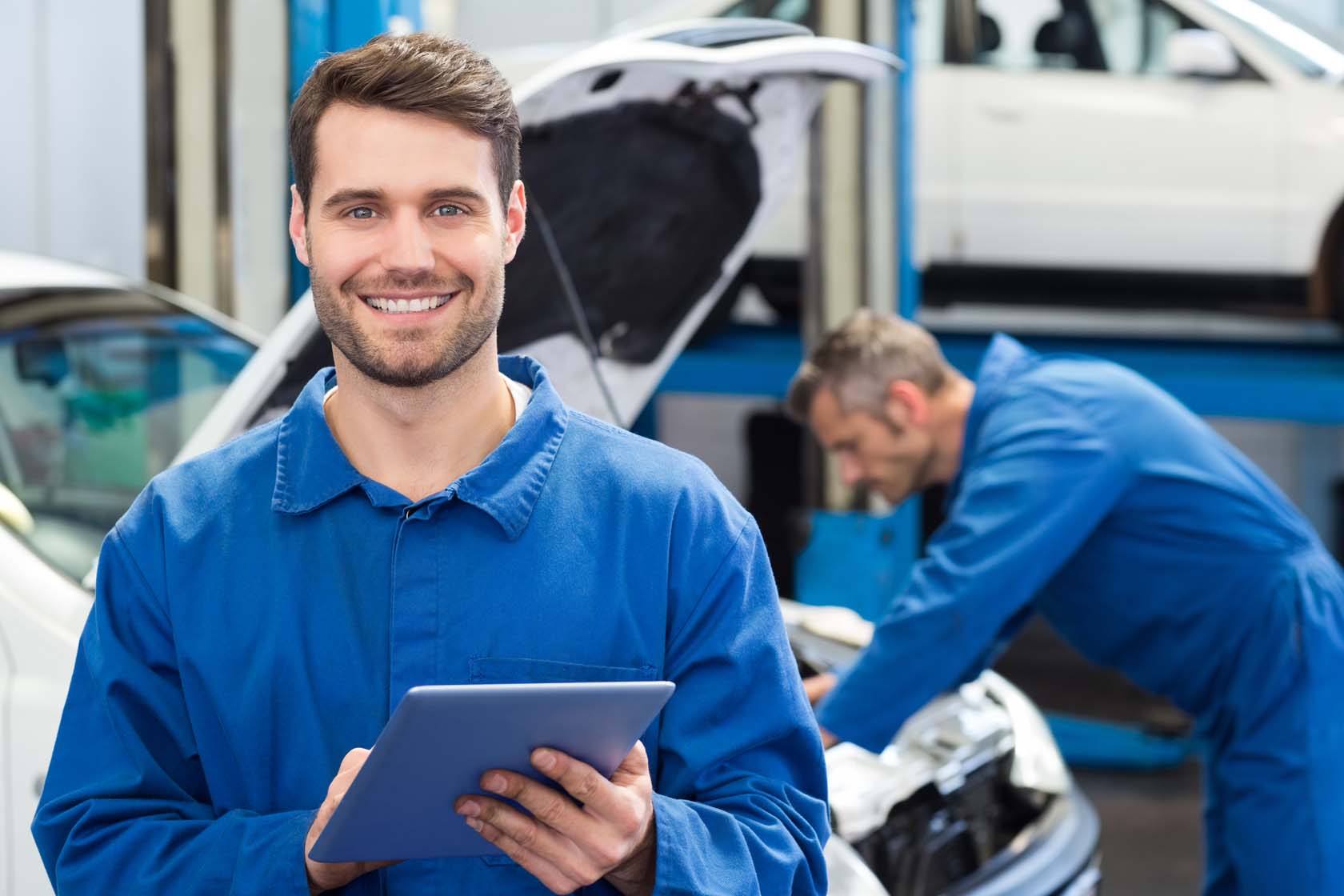 motor mechanics servicing a car